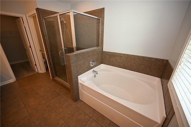 bathroom with tile patterned floors, toilet, and independent shower and bath