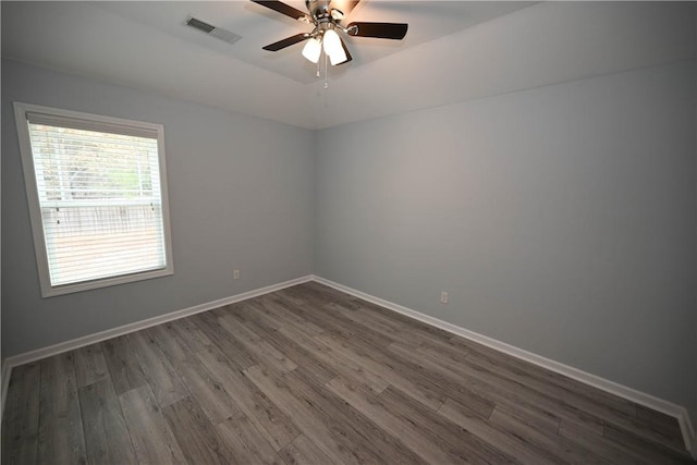 spare room featuring ceiling fan and dark hardwood / wood-style floors