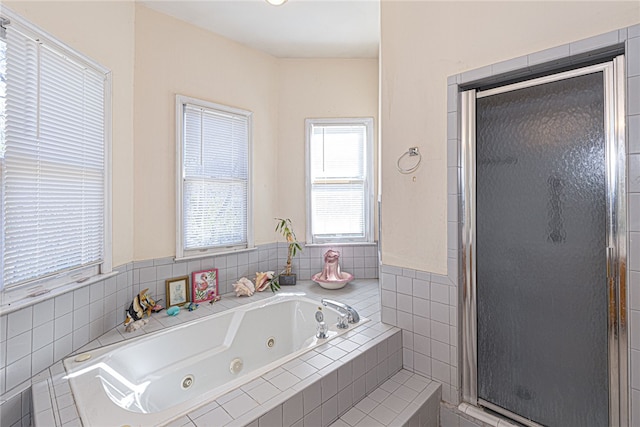 bathroom featuring shower with separate bathtub