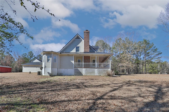 rear view of property featuring covered porch