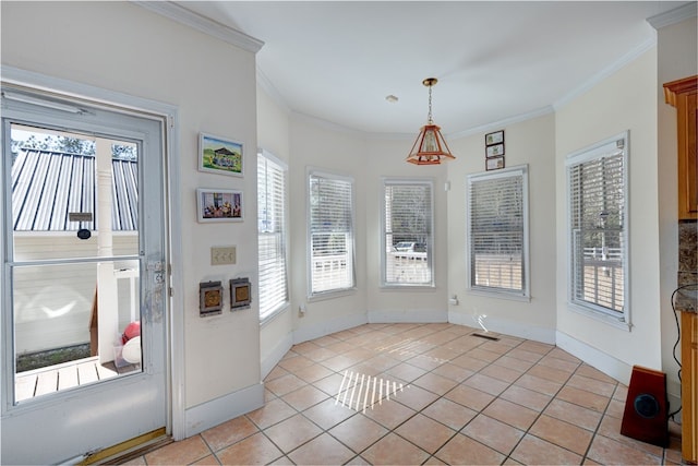 dining room with light tile patterned floors, ornamental molding, and a healthy amount of sunlight