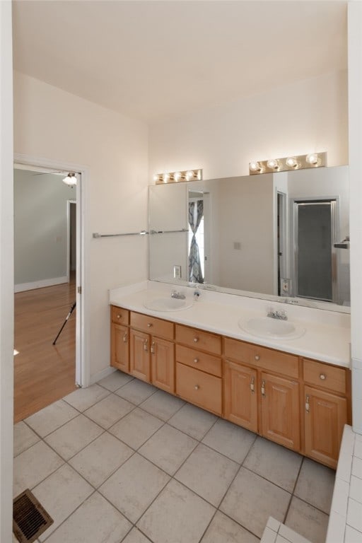 bathroom featuring tile patterned flooring and vanity