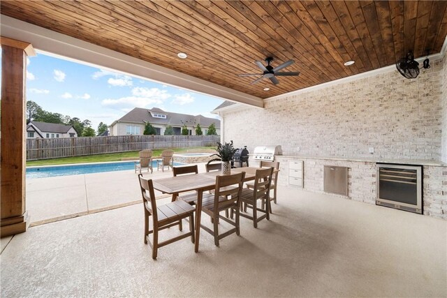 110 Newton Way, Auburn, AL 36830 - fenced backyard featuring exterior kitchen, outdoor dining area, a patio area, a ceiling fan, and wine cooler