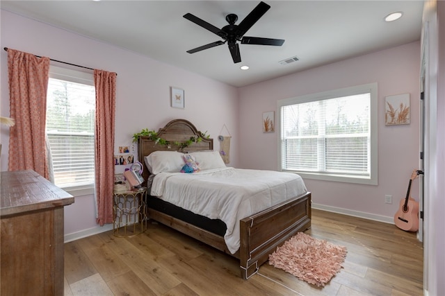 bedroom featuring light wood-style flooring, visible vents, baseboards, and recessed lighting