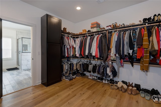 walk in closet featuring light wood finished floors