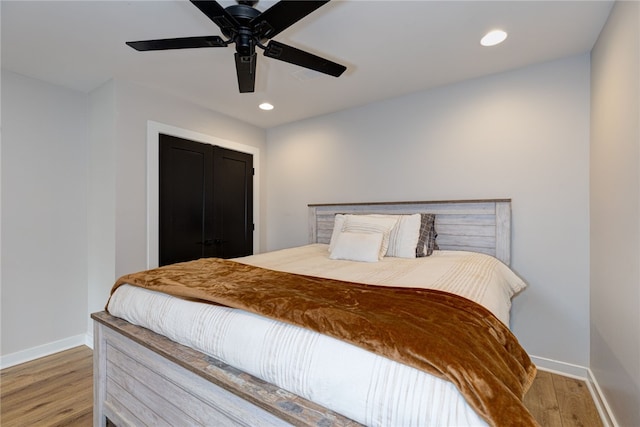 bedroom featuring recessed lighting, wood finished floors, and baseboards