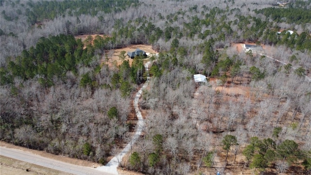 birds eye view of property featuring a view of trees