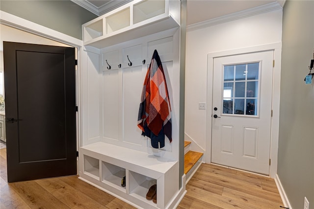 mudroom with baseboards, light wood-type flooring, and crown molding