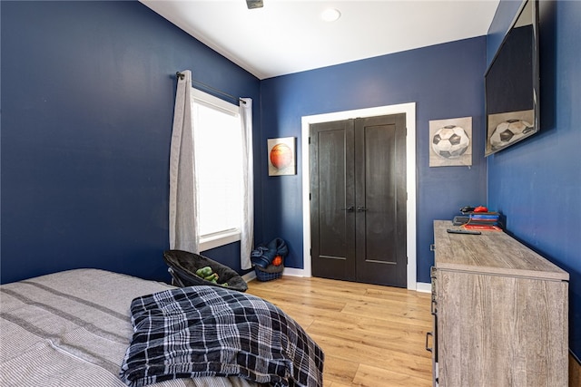 bedroom with wood finished floors and baseboards