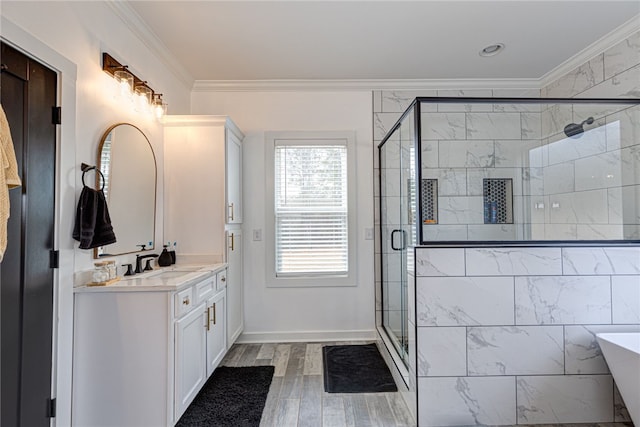 bathroom featuring a stall shower, wood finished floors, vanity, and crown molding