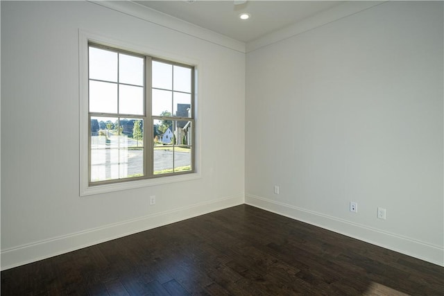 spare room with dark hardwood / wood-style floors and ornamental molding