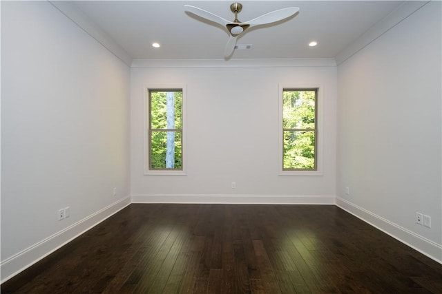 empty room featuring ceiling fan, a healthy amount of sunlight, dark hardwood / wood-style flooring, and ornamental molding