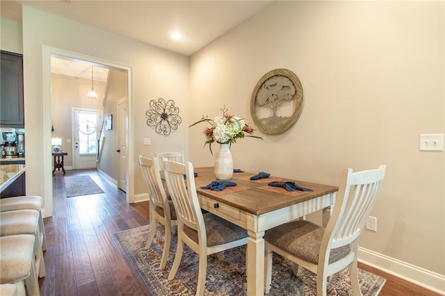 dining space featuring dark hardwood / wood-style floors