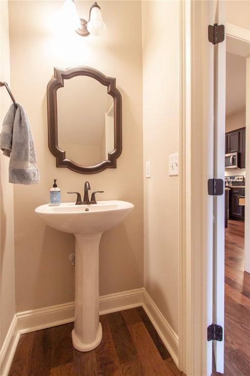 bathroom featuring wood-type flooring and sink