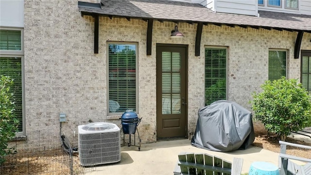 doorway to property featuring central air condition unit