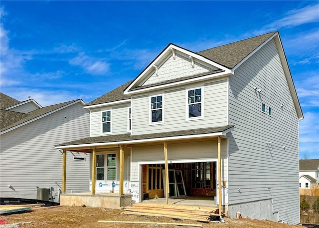 rear view of property with cooling unit and a porch