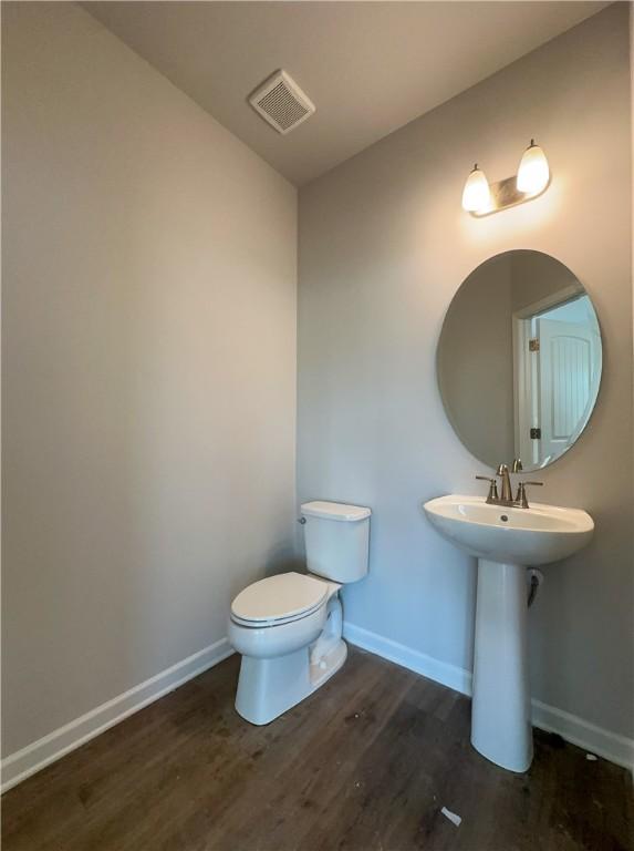 2260 Red Tail Ln, Auburn, AL 36879 - half bathroom featuring wood finished floors, baseboards, toilet, and a sink