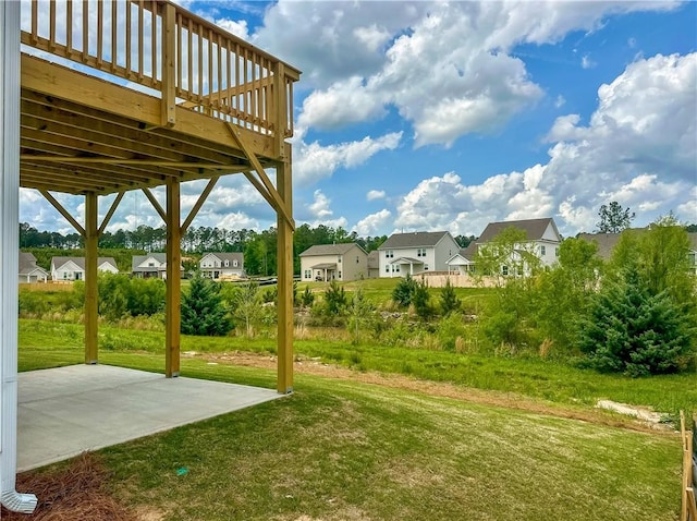 2260 Red Tail Ln, Auburn, AL 36879 - view of green lawn featuring a residential view, a patio, and a wooden deck