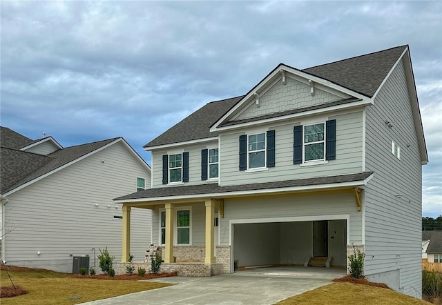 craftsman house with cooling unit, roof with shingles, covered porch, concrete driveway, and a garage