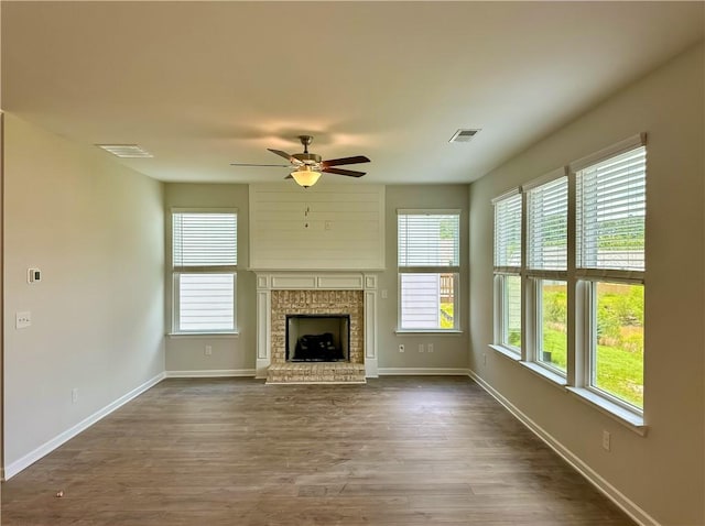 2260 Red Tail Ln, Auburn, AL 36879 - unfurnished living room featuring a ceiling fan, healthy amount of natural light, baseboards, and dark wood-type flooring