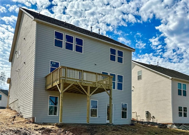 back of property with a balcony