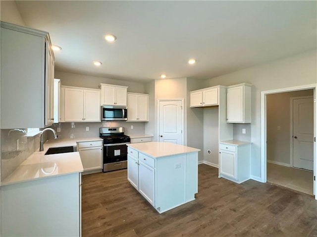 2260 Red Tail Ln, Auburn, AL 36879 - kitchen featuring stainless steel appliances, a sink, dark wood-style floors, a center island, and recessed lighting