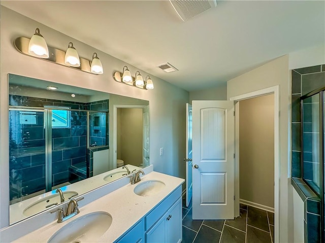 2260 Red Tail Ln, Auburn, AL 36879 - full bath featuring a shower stall, tile patterned floors, double vanity, and toilet