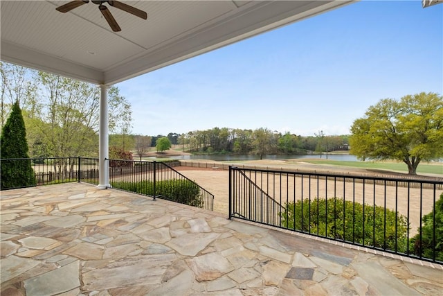 view of patio / terrace featuring ceiling fan and a water view