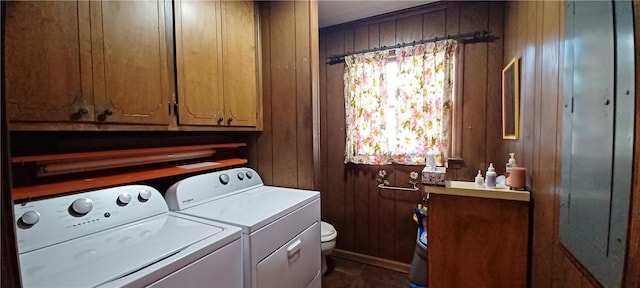 laundry area featuring laundry area, washing machine and dryer, and wood walls