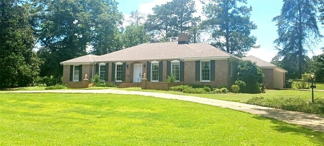 2104 Oak Bowery Rd, Opelika, AL 36801 - view of side of property featuring brick siding, a chimney, and a lawn