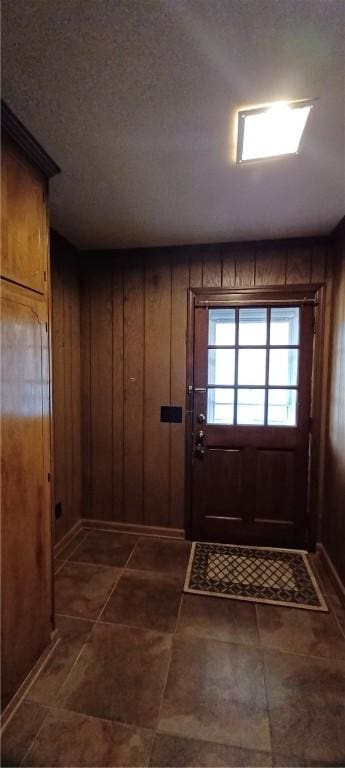 entryway with wooden walls