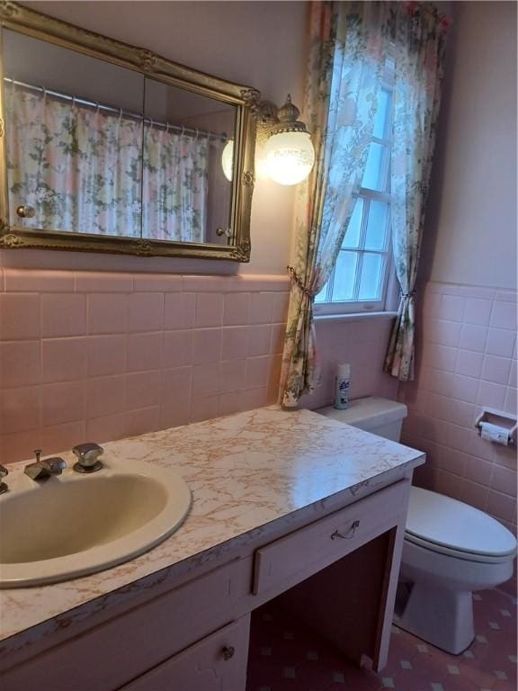 2104 Oak Bowery Rd, Opelika, AL 36801 - bathroom featuring tile walls, toilet, vanity, a wainscoted wall, and a shower with curtain