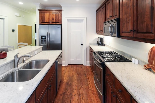 kitchen featuring light stone countertops, appliances with stainless steel finishes, crown molding, and sink