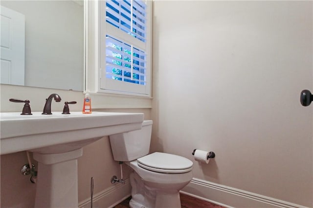 bathroom with sink, hardwood / wood-style floors, and toilet