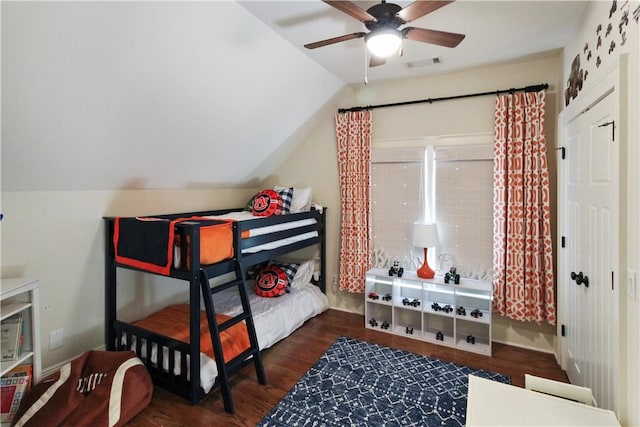 bedroom featuring dark hardwood / wood-style floors, vaulted ceiling, and ceiling fan