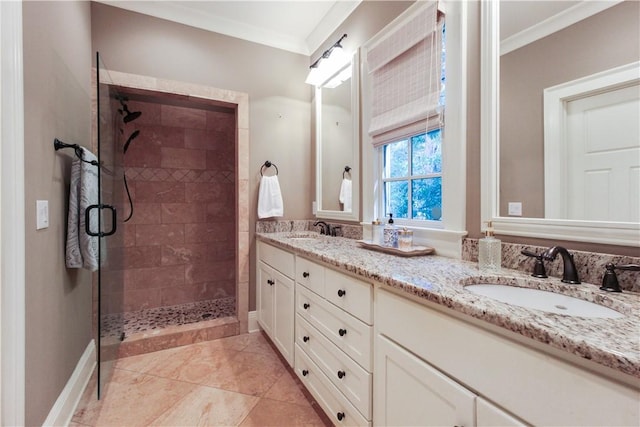 bathroom with tile patterned floors, vanity, an enclosed shower, and ornamental molding