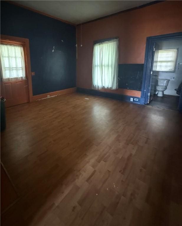 133 Bridges St, Notasulga, AL 36866 - unfurnished living room featuring wood finished floors and healthy amount of natural light