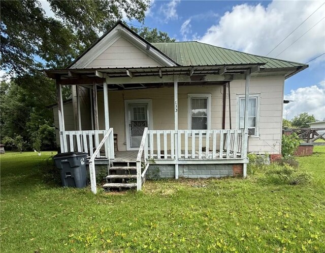 133 Bridges St, Notasulga, AL 36866 - bungalow-style house featuring a porch, a front yard, and a metal roof