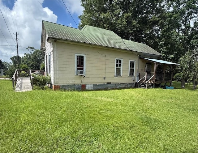 133 Bridges St, Notasulga, AL 36866 - back of property featuring a yard, cooling unit, a metal roof, and crawl space