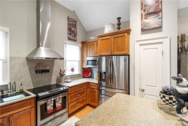 3403 Double Eagle Ln, Opelika, AL 36801 - kitchen featuring appliances with stainless steel finishes, exhaust hood, vaulted ceiling, light countertops, and decorative backsplash