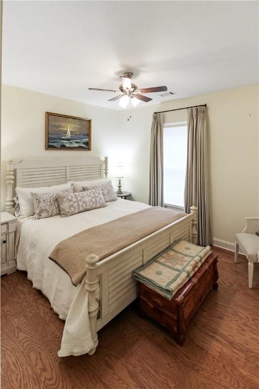 3403 Double Eagle Ln, Opelika, AL 36801 - bedroom with ceiling fan, dark wood-style flooring, and baseboards