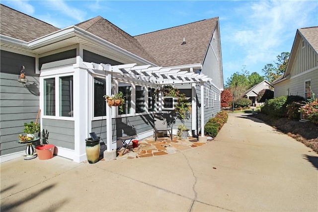 3403 Double Eagle Ln, Opelika, AL 36801 - view of home's exterior featuring a shingled roof, a pergola, a patio, and concrete driveway