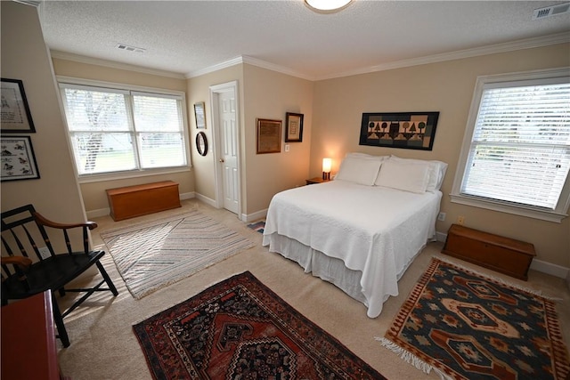bedroom featuring a textured ceiling, multiple windows, and visible vents