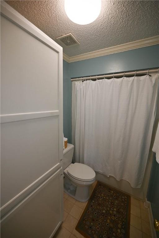 bathroom featuring a textured ceiling, visible vents, crown molding, toilet, and tile patterned flooring