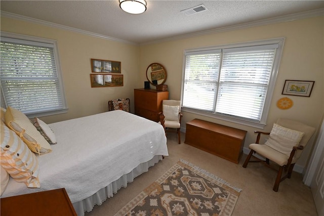 bedroom with ornamental molding, a textured ceiling, light carpet, and visible vents