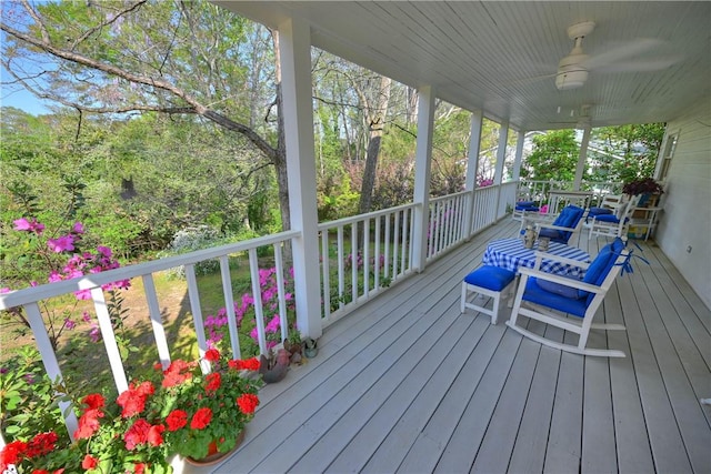 wooden deck featuring a ceiling fan and a porch