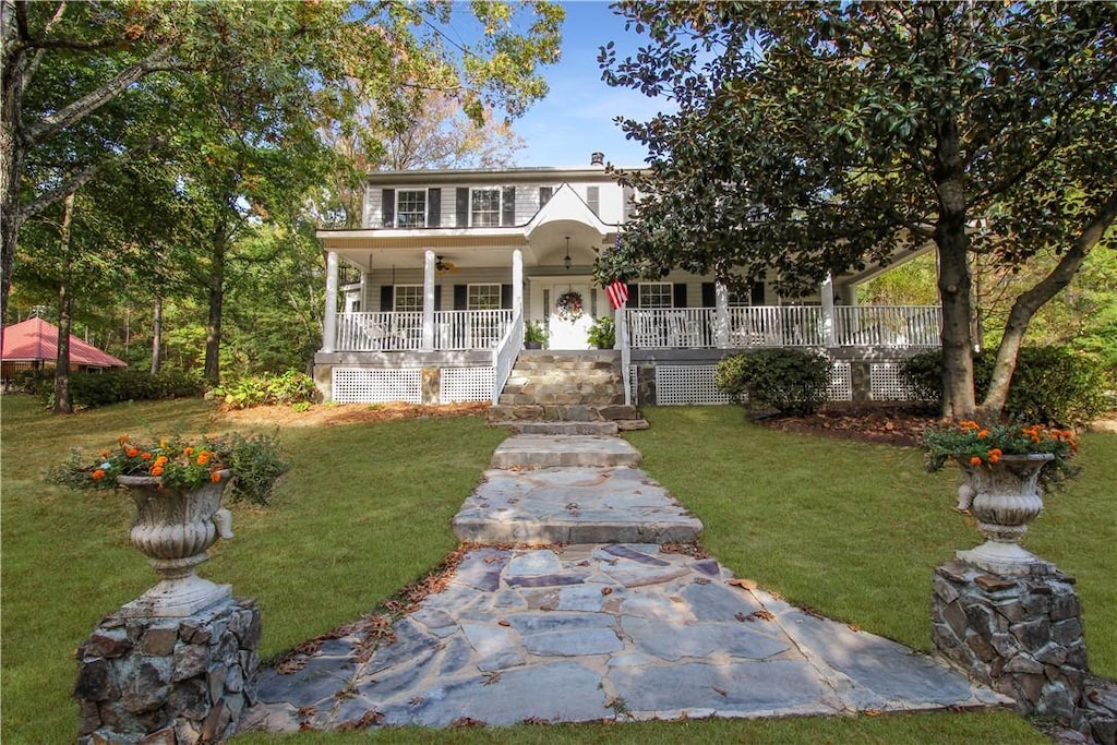 view of front of property with covered porch and a front yard