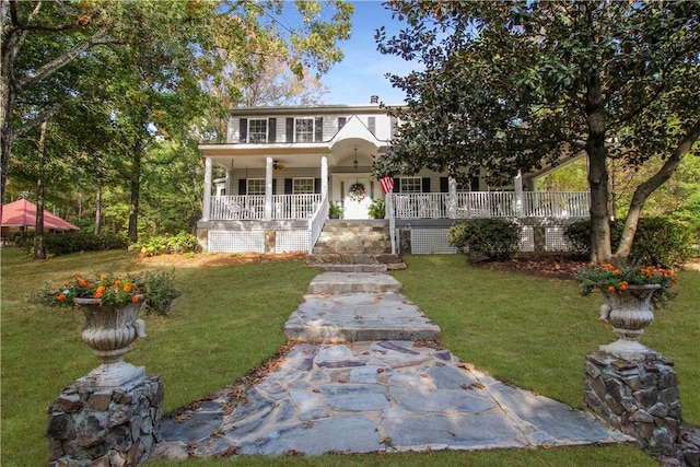 view of front of property with covered porch and a front yard