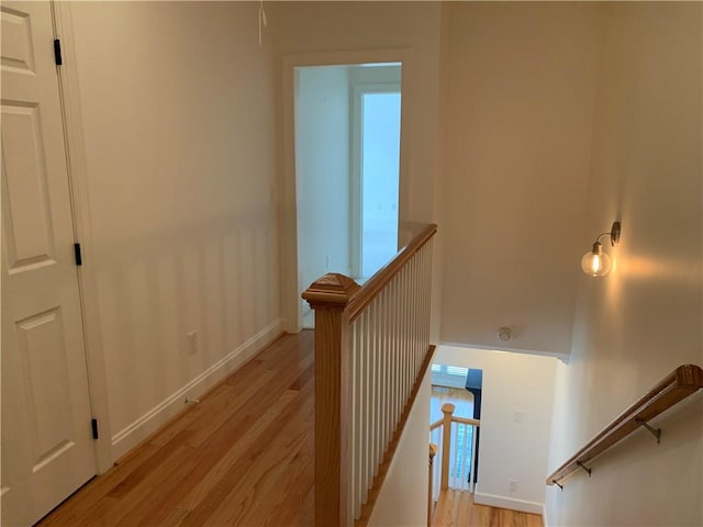 staircase with wood finished floors and baseboards