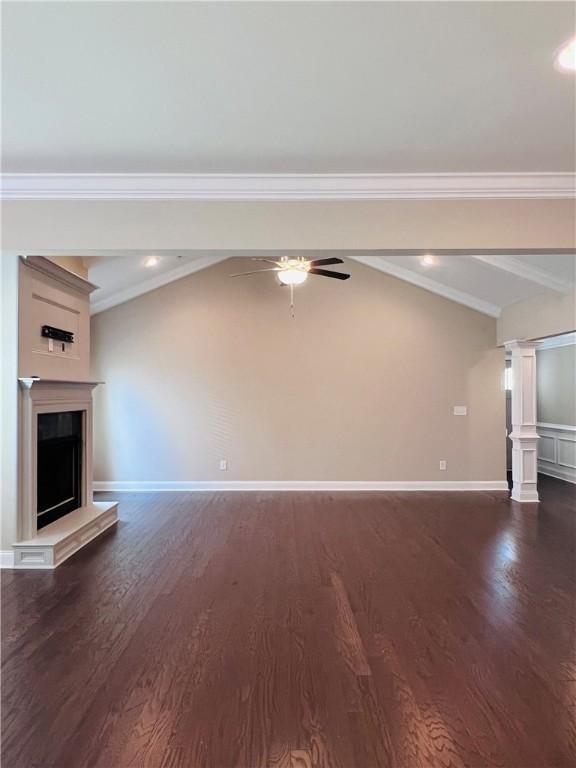 1024 Hampstead Ln, Opelika, AL 36801 - unfurnished living room featuring dark wood-style flooring, ceiling fan, a fireplace with raised hearth, ornamental molding, and recessed lighting